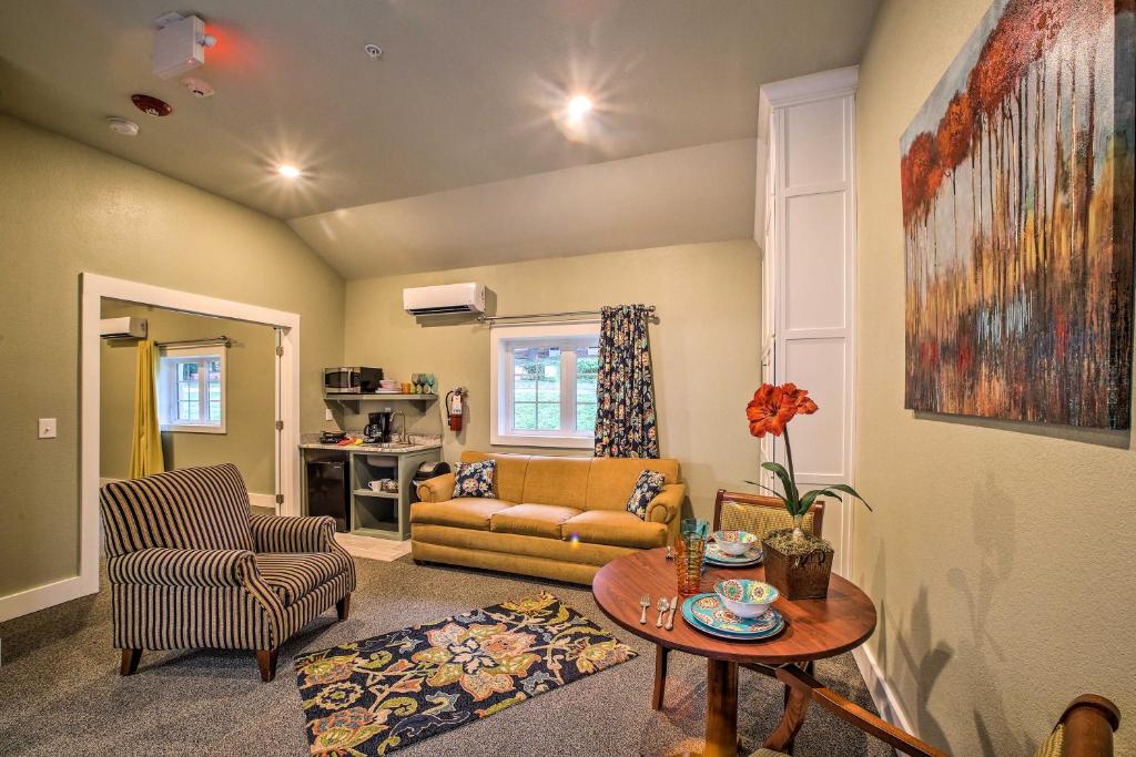 a living room with a couch and a table at Welcoming Downtown Branson Cottage with Pool Access! in Branson