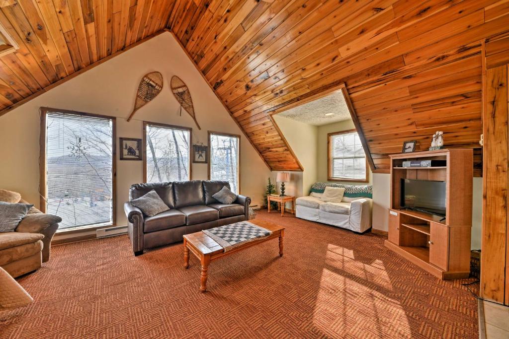 a living room with a couch and a tv at Ski-In and Ski-Out Ghent Cabin with Mountain Views! in Ghent
