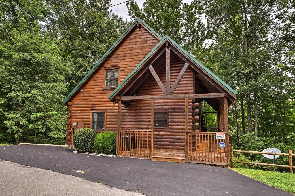 a log cabin with a gate in front of it at Sevierville Cabin with Hot Tub, Grill and Pool Table! in Sevierville