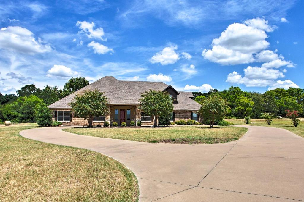 a home with a driveway leading to a house at Spacious Stallion Lake Ranch Home with Patio in Van