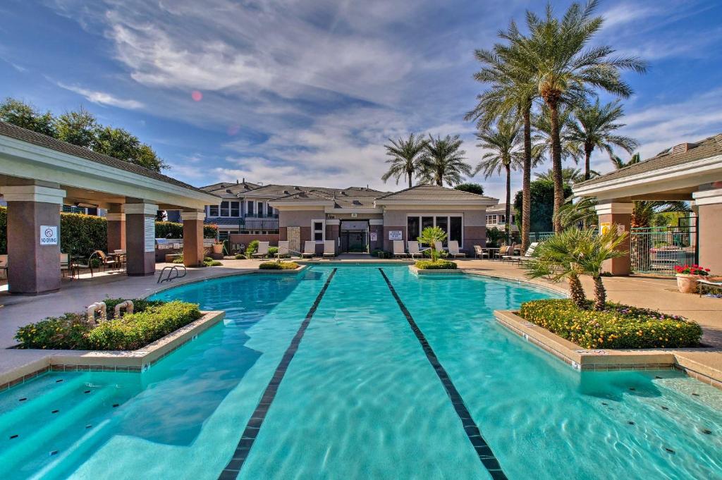 a swimming pool in front of a house at Upscale Scottsdale Getaway with Golf Course Views! in Scottsdale