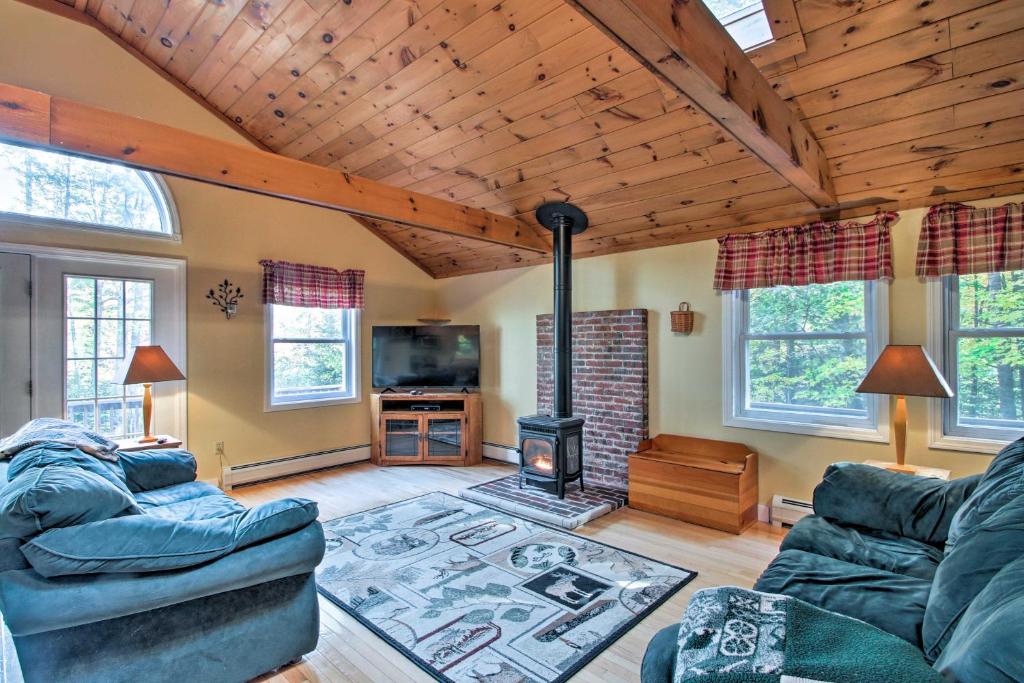 a living room with two couches and a fireplace at Bethel Chalet with Hot Tub 3 Miles to Sunday River! in Bethel