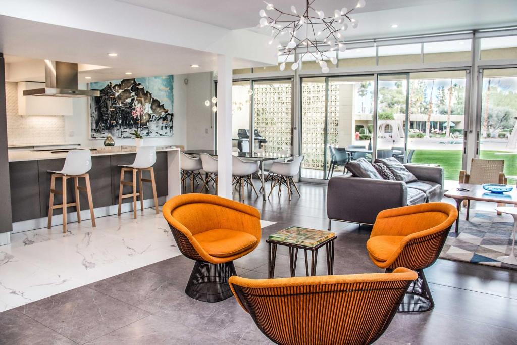 Il comprend un salon avec des chaises orange et une cuisine. dans l'établissement Luxe Palm Desert Home Patio, Grill and Mtn Views!, à Palm Desert