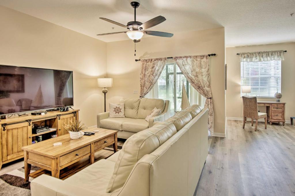 a living room with a couch and a tv at Kissimmee Retreat with Pool Access Less Than 4 Mi to Disney! in Orlando