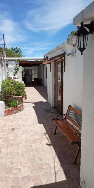a bench sitting on a patio next to a building at Apartamentos Flor de Lis in La Paloma