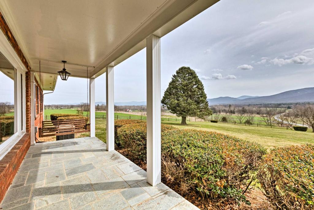 an empty porch of a house with a view of a field at Quaint Elkton Home near Shenandoah National Park! in Elkton