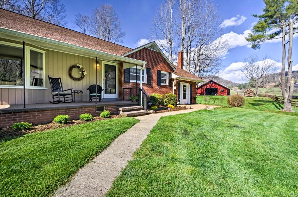 a house with a green lawn in front of it at Scenic Canton Home with Sunroom - Near Asheville! in Canton