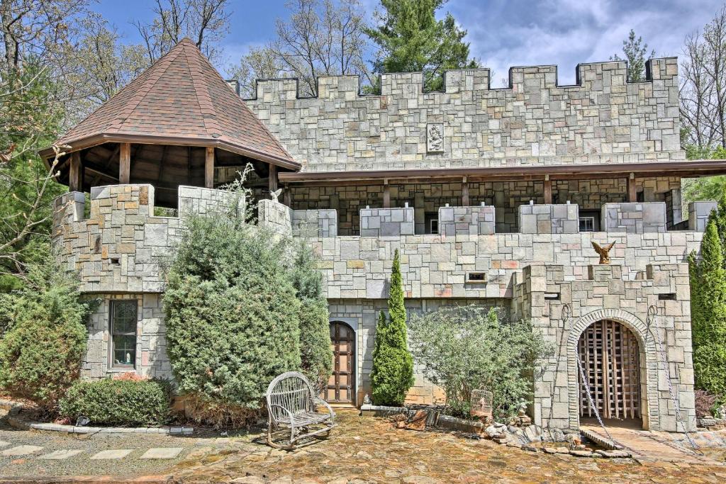 a large stone house with a stone wall at 11 Mi to Dtwn Murphy Gem with Hot Tub and Mtn Views! in Murphy