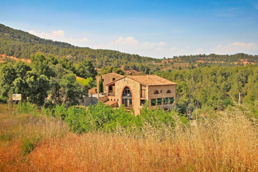 a house sitting on top of a hill at Mas Del Cigarrer Allotjament Rural in Horta de San Joan