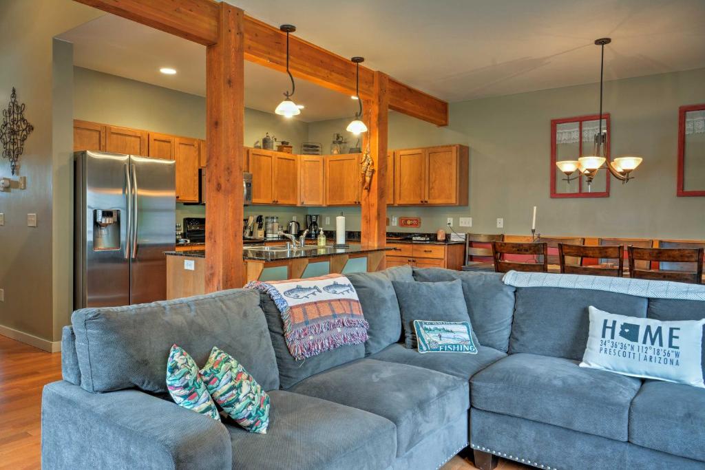 a living room with a blue couch and a kitchen at Bozeman Getaway with Mountain Views, Near Downtown in Bozeman