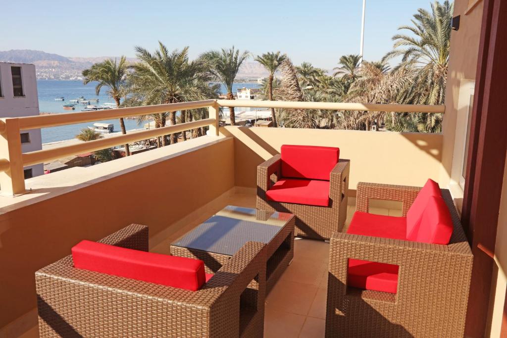 a balcony with chairs and a view of the beach at La Riva Hotel in Aqaba