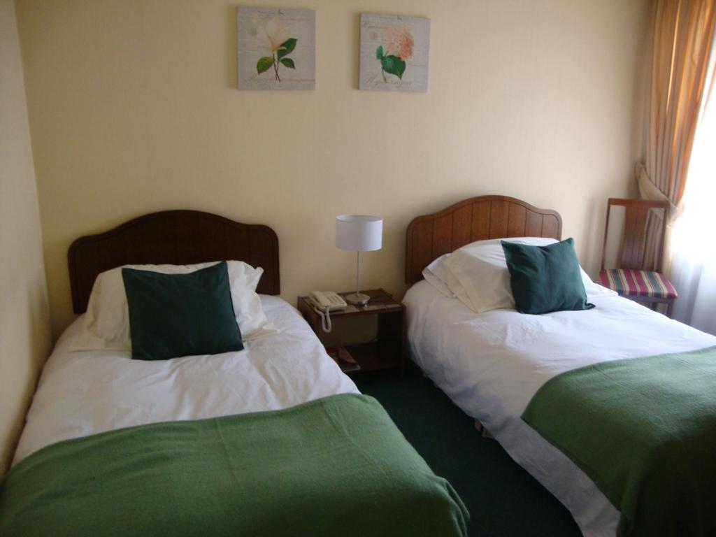 Postel nebo postele na pokoji v ubytování Hotel Las Flores