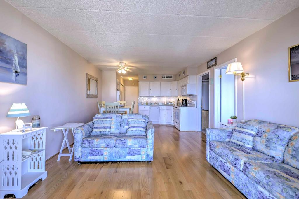 a living room with two couches and a kitchen at Beachfront North Wildwood Condo with Ocean Views! in North Wildwood