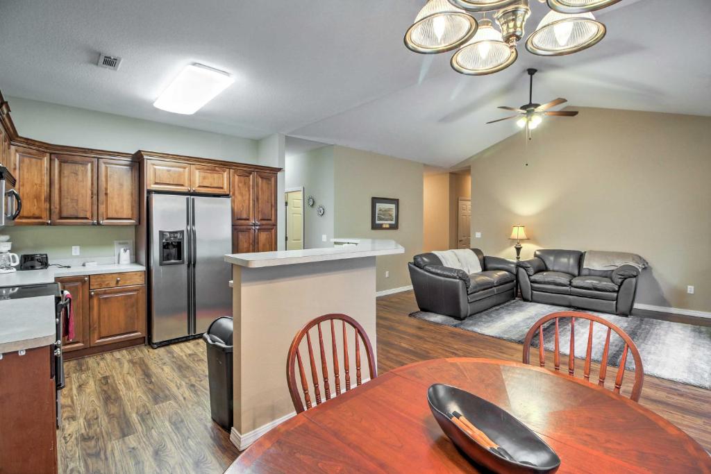 a kitchen and living room with a table and chairs at Branson Home with Deck Walk to The Strip and Creek! in Branson