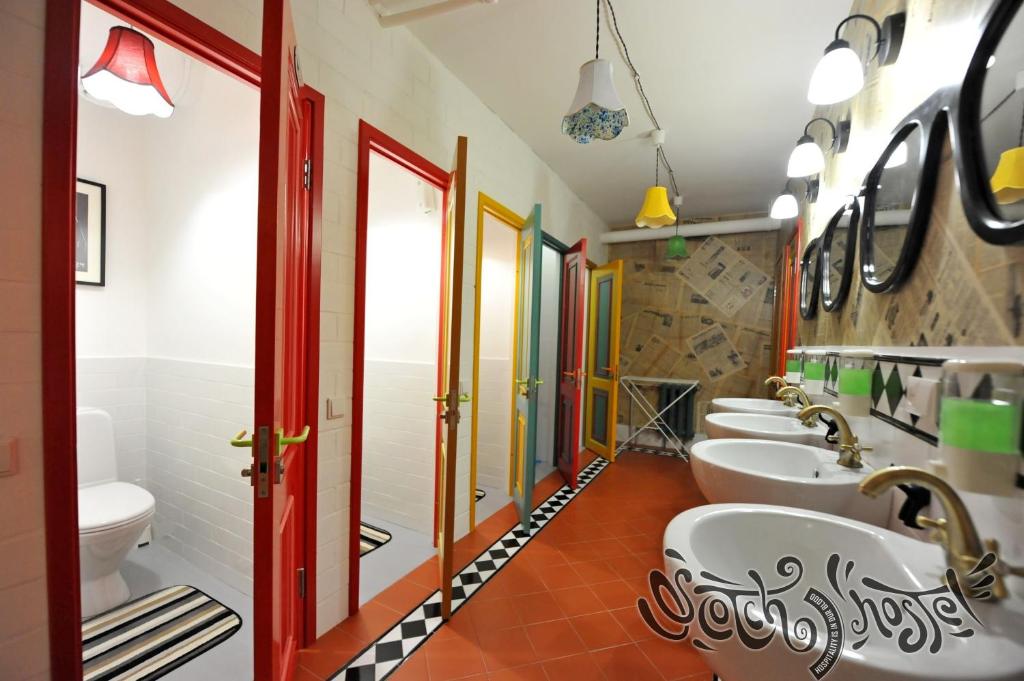 a bathroom with a row of sinks and toilets at Scotch Hostel in Volgograd