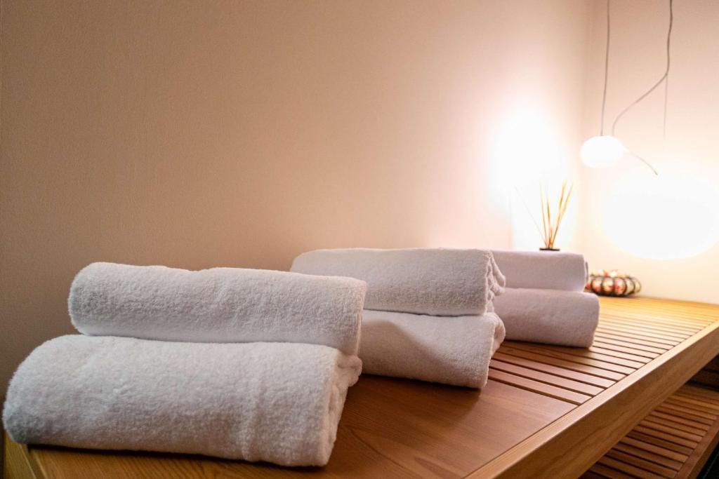 three towels sitting on a table in a room at Hotel Cappello D'Oro, BW Signature Collection in Bergamo