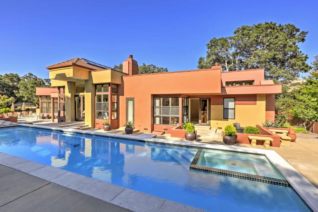 a house with a swimming pool in front of it at Chic California Escape with Pool, Hot Tub and Patio! in Salinas