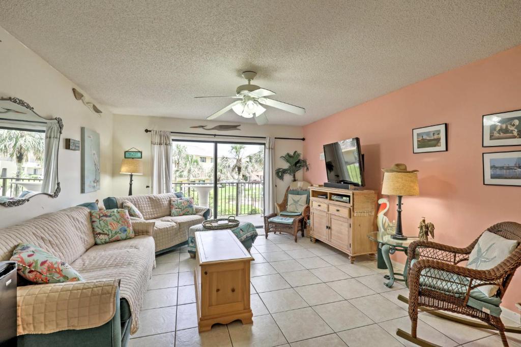 a living room with a couch and a tv at St Augustine Resort Condo - Walk to Crescent Beach in St. Augustine