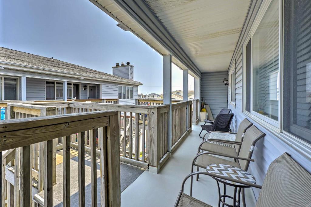 a balcony with chairs and tables on a house at Central Sea Isle City Condo - 1 Block to the Beach in Sea Isle City
