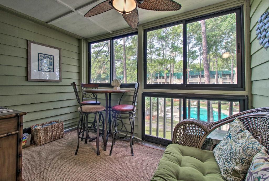 a screened in porch with a table and chairs at Oceanfront Hilton Head Island Condo! in Hilton Head Island