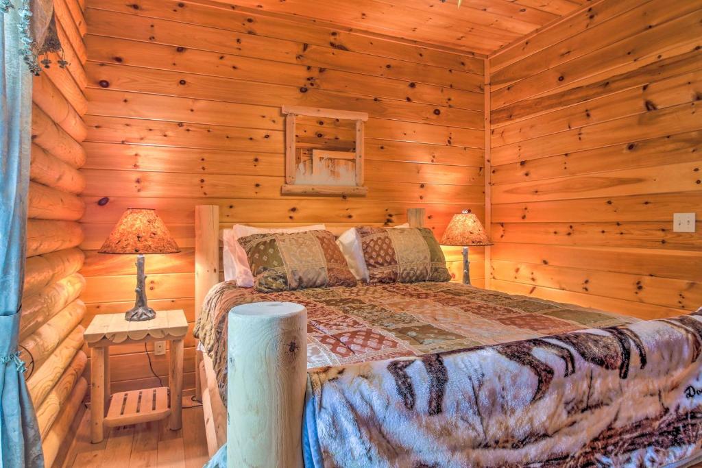 a bedroom with a bed in a log cabin at Spacious Twin Mountain Vacation Rental on 5 Acres! in Twin Mountain