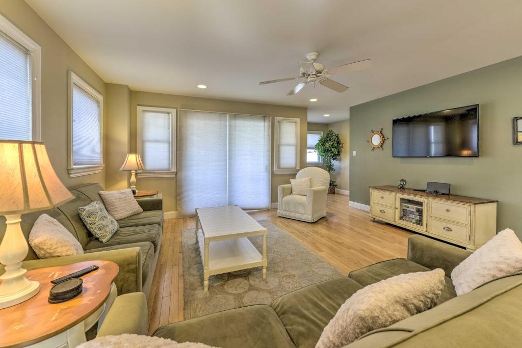 a living room with a couch and a table at Wildwood Townhome with Patio 1 Block To The Beach! in Wildwood