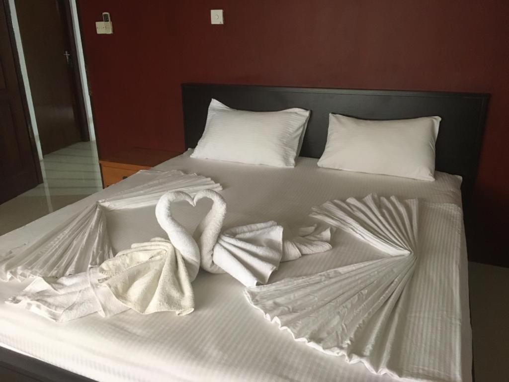 Postel nebo postele na pokoji v ubytování Nallur Residence