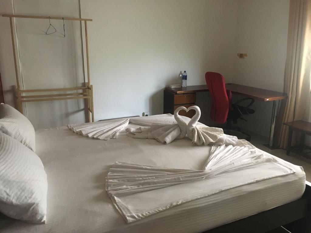 Postel nebo postele na pokoji v ubytování Nallur Residence