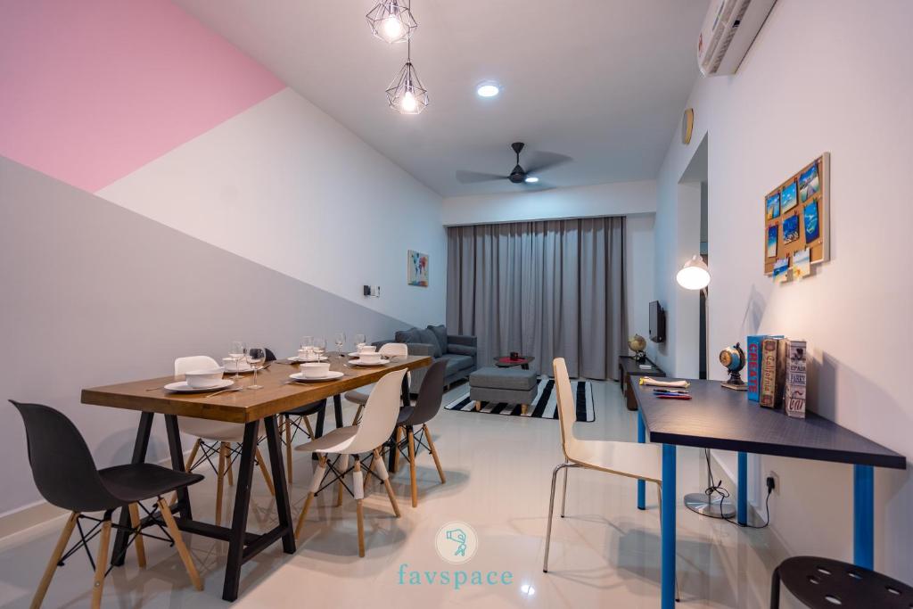 a dining room with a long table and chairs at Lovely 3-bedroom condo with pool for 8 pax - Cheras in Kuala Lumpur