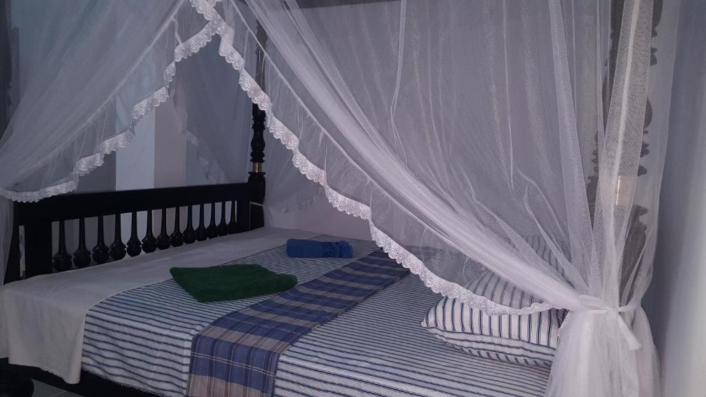 Postel nebo postele na pokoji v ubytování Samudra Guest House