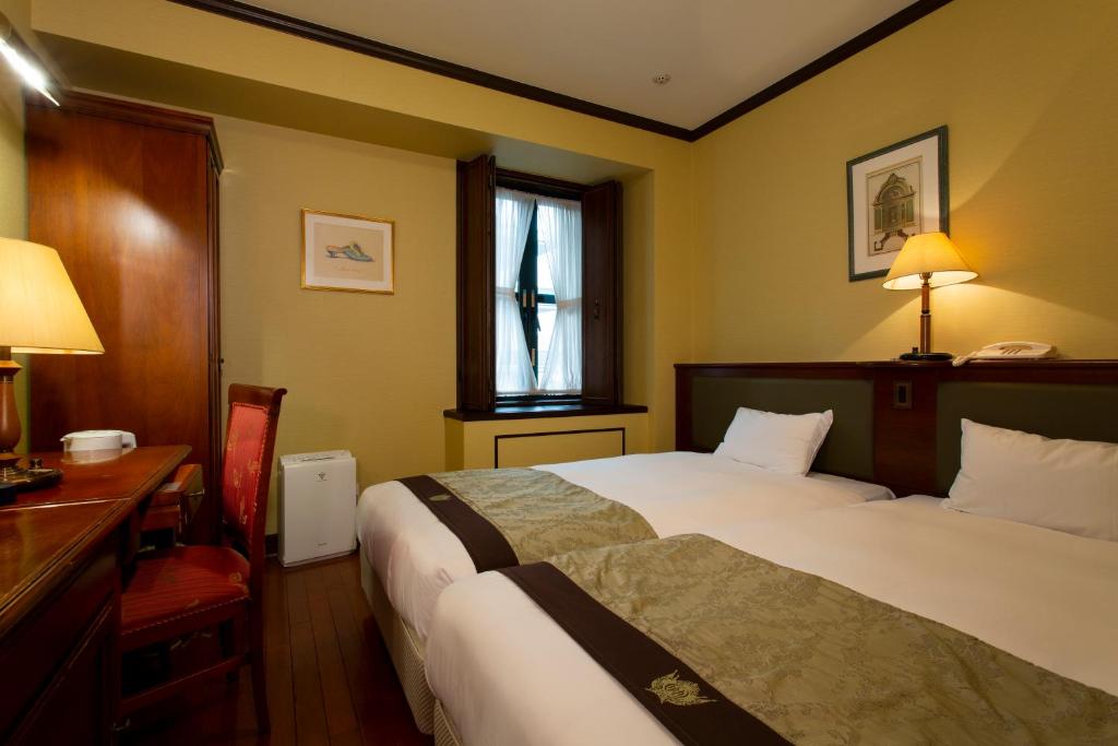 Postel nebo postele na pokoji v ubytování Hotel Monterey Osaka