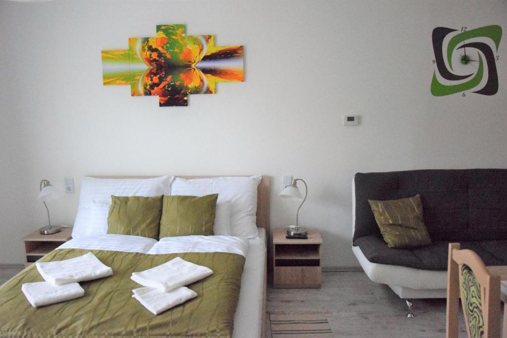 A bed or beds in a room at Downtown Apartment Miskolc