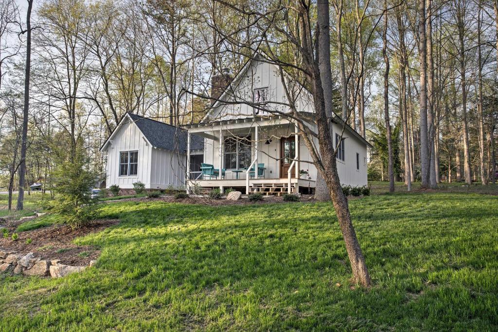 a white house in the middle of a field at Enchanting Andersonville Home Steps to Norris Lake in Andersonville