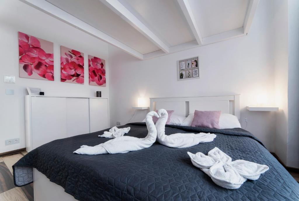 a bedroom with two swans made out of towels on a bed at Bilkova Old Town Residence in Prague