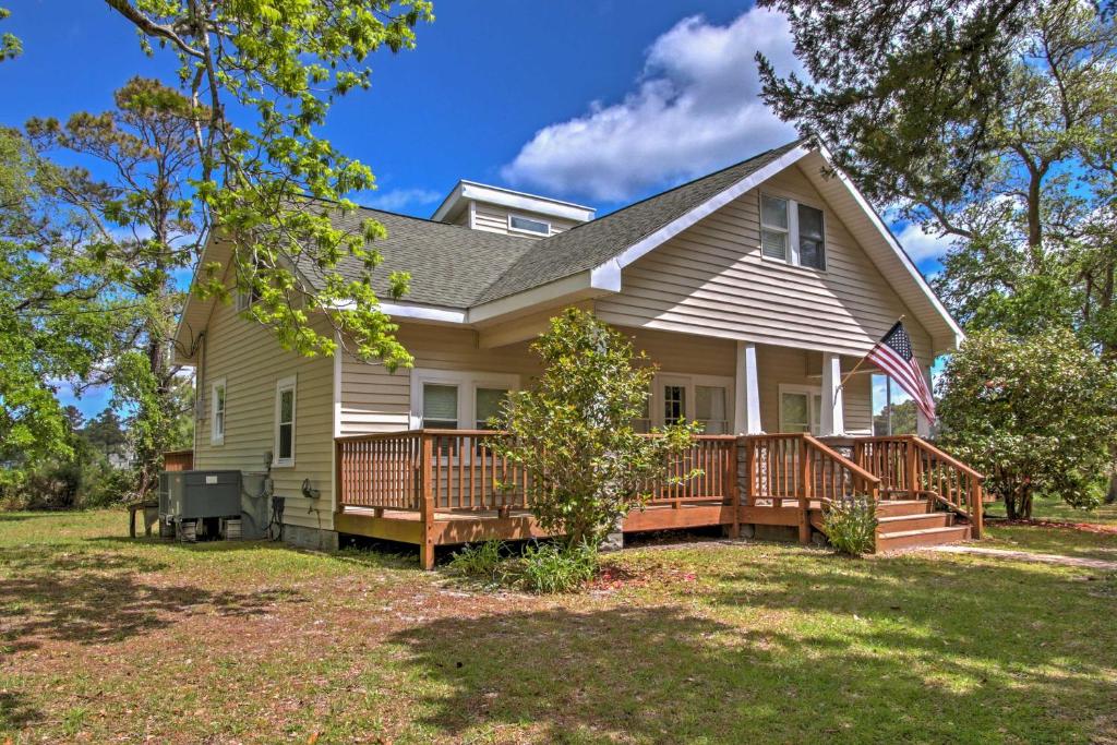 a home with a large deck on a lawn at Secluded and Quiet Coastal Home 1 Mile to Boat Ramp in Sealevel