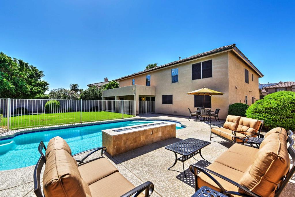 a backyard with a swimming pool and a house at Spacious Litchfield Park Home with Yard, Heated Pool in Litchfield Park