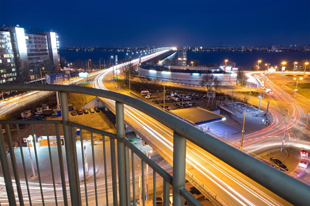 a night view of a city with traffic on a highway at Staybridge Mini-Hotel in Most City PANORAMIC RIVER VIEW in Dnipro