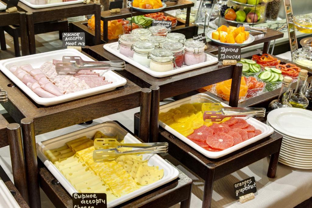 a buffet with many different types of food on display at Pushka INN hotel in Saint Petersburg