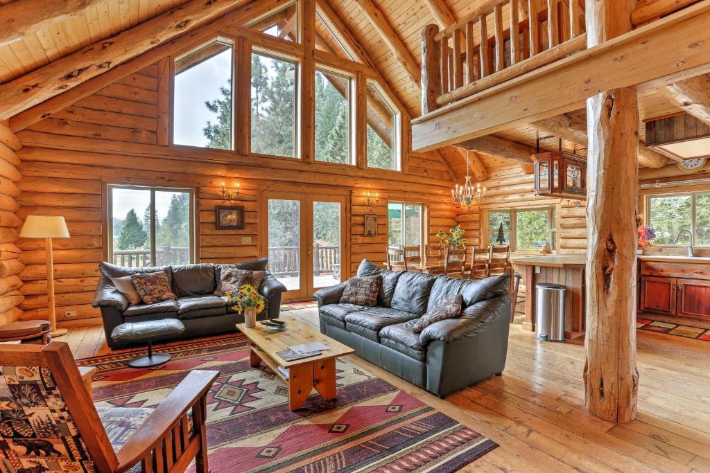 a living room with leather furniture in a log cabin at Log Home on 40 Private Acres By Mt Shasta Ski Park in McCloud