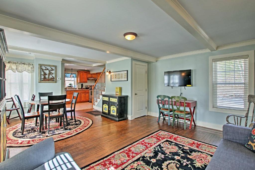 a living room with a table and chairs and a kitchen at Remodeled Farmhouse in Waterford Near 2 Beaches! in Waterford