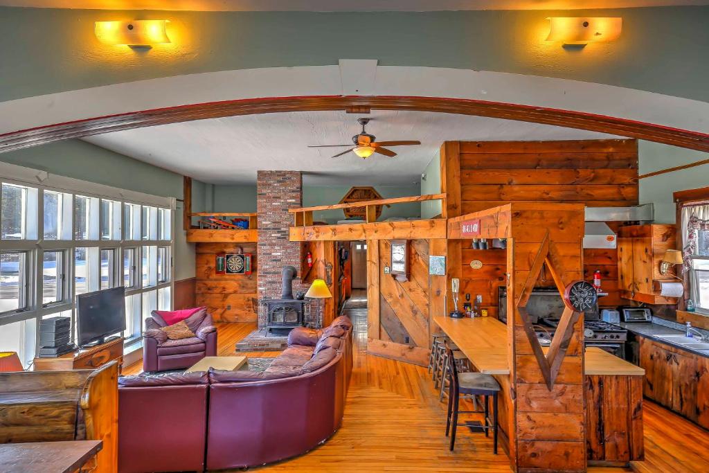 a living room with a couch and a table at East Burke Home on Kingdom Trails Near Ski Resort in East Burke