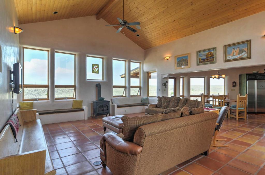 a living room with couches and a fireplace at Traditional Taos Home 26 Acres with Mountain Views in Taos
