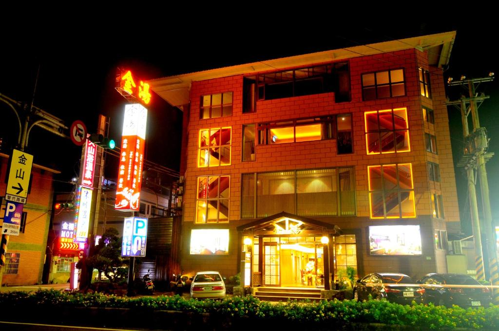 a building on a city street at night at Jin Spa Resort Hotel in Jinshan