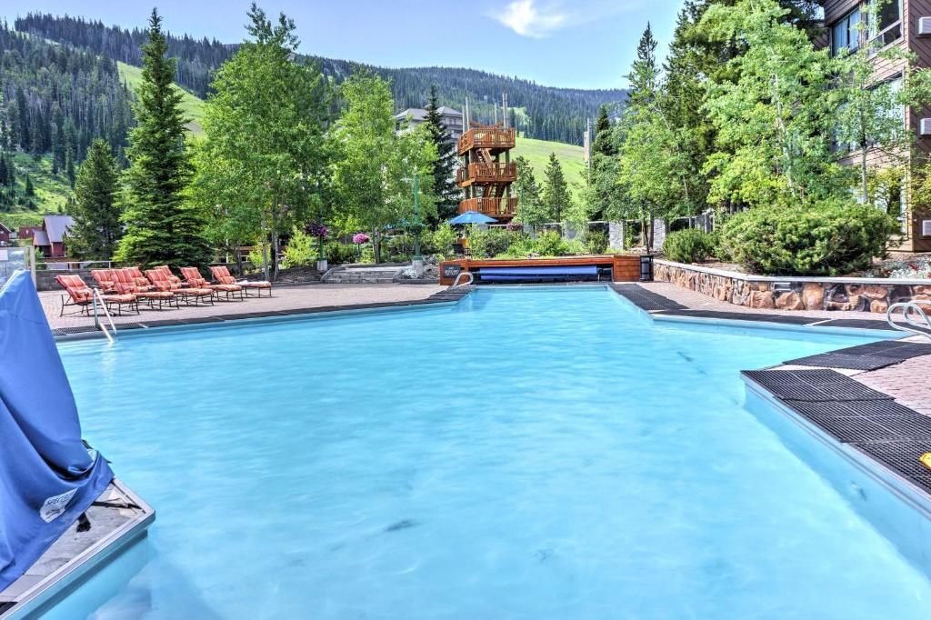 a swimming pool in the middle of a resort at Big Sky Condo with Mountain Views, Hike, Ski and Fish! in Big Sky