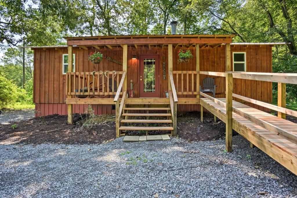 une cabane en bois avec un escalier menant à la porte d'entrée. dans l'établissement Kentucky Cabin with 2 Fishing Ponds and Trail Access, à New Concord