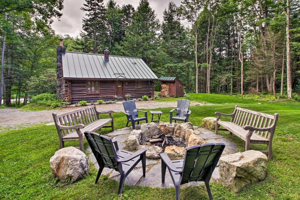 a fire pit with four chairs and a log cabin at Award-Winning Log Cabin, Top 5 in New England! in Londonderry
