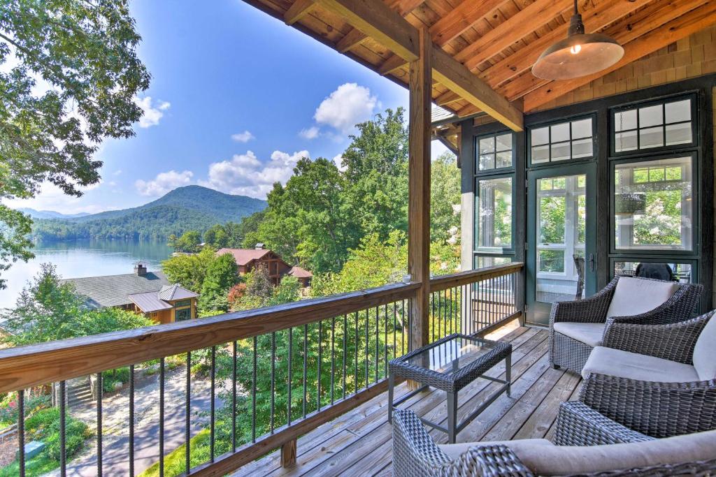 a screened porch with chairs and a view of a lake at Lake Santeetlah Home with Gas Grill, Walk to Marina! in Robbinsville