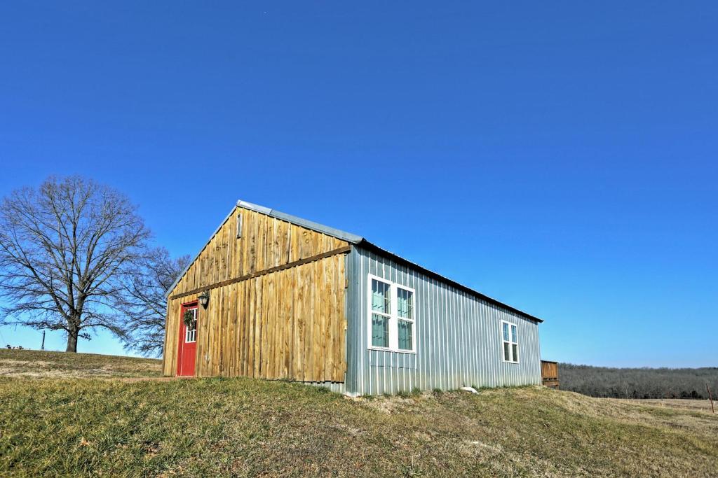 a barn sitting on top of a hill at Secluded Everton Retreat with Ozark Mountain Views! in Everton