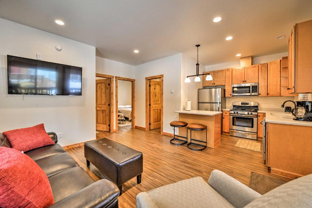 a living room with a couch and a kitchen at Fishermans Cabin in Soldotna Near Kenai River! in Soldotna