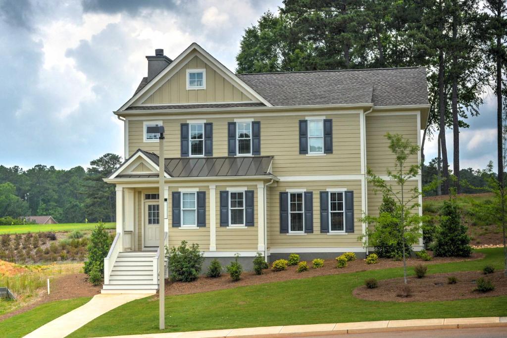 a yellow house with a gray roof at Near Sugar Creek Spacious Family-Friendly Retreat in Greensboro
